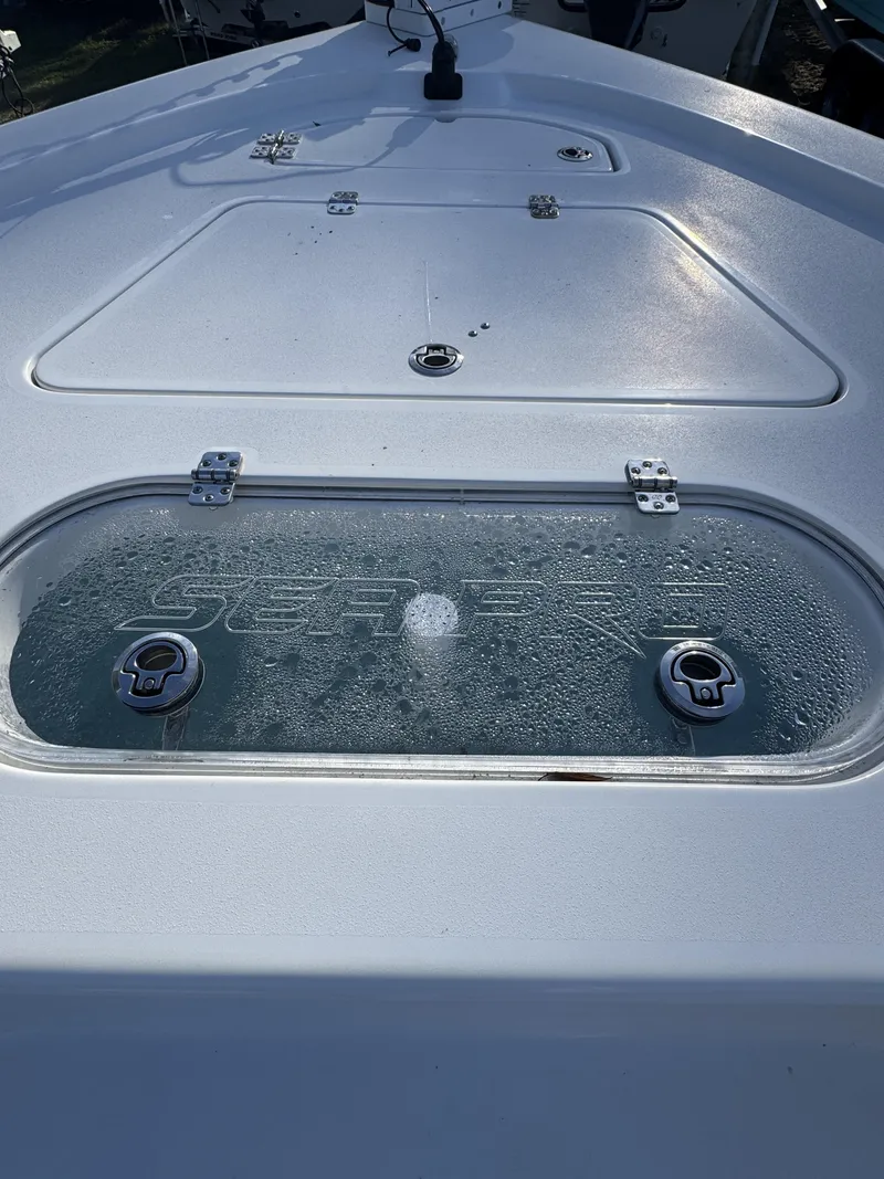 Slide: The Image of 2025 Sea Pro Bay 250 boat deck with storage compartments. - 9