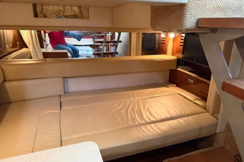 Slide: The Image of 2011 Sea Ray Sundancer 370 interior with beige leather seating and wooden accents. - 11