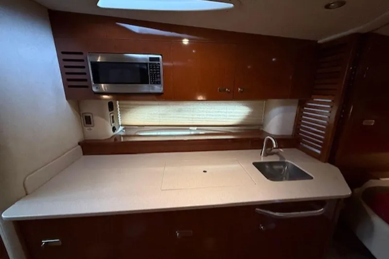 Slide: The Image of Interior of 2011 Sea Ray Sundancer 370 yacht kitchen with sink and microwave. - 13