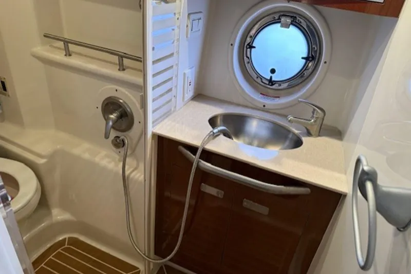 Slide: The Image of 2011 Sea Ray Sundancer 370 bathroom with sink, shower, and porthole window. - 20
