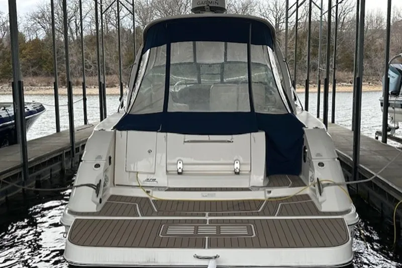 Slide: The Image of 2011 Sea Ray Sundancer 370 docked, rear view with covered cockpit and swim platform. - 21