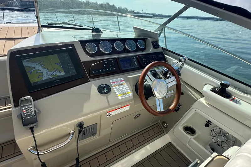 Slide: The Image of Cockpit of 2011 Sea Ray Sundancer 370 with navigation display and steering wheel. - 22