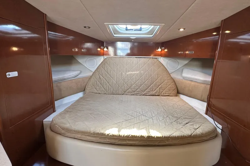 Slide: The Image of Luxurious cabin interior of 2011 Sea Ray Sundancer 370 with cozy bed and wood finish. - 23