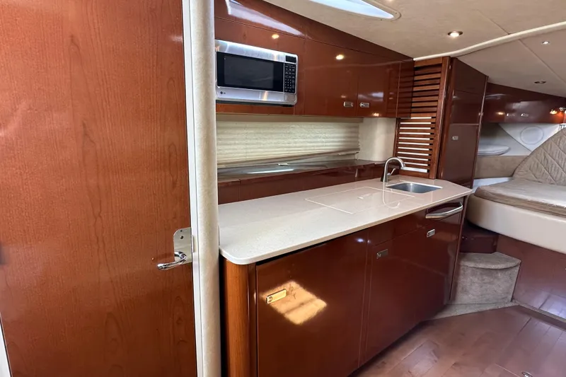 Slide: The Image of Luxurious 2011 Sea Ray Sundancer 370 interior with kitchenette and cozy sleeping area. - 24