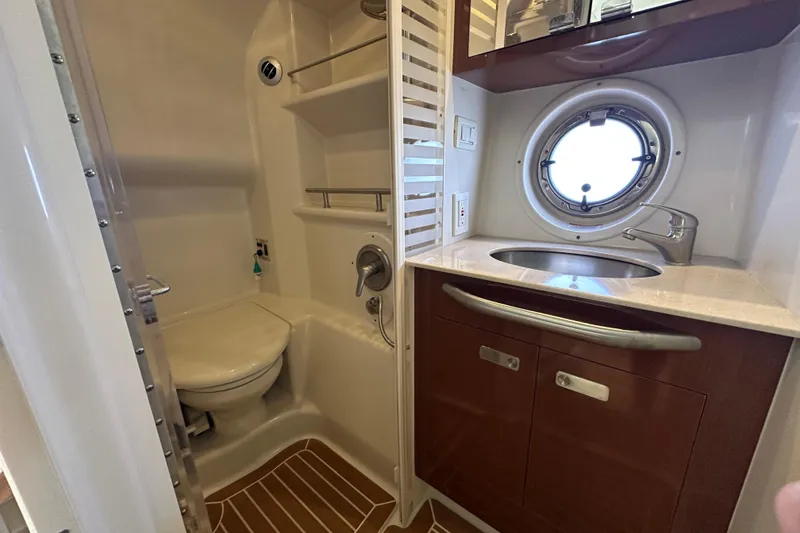 Slide: The Image of Luxurious bathroom in 2011 Sea Ray Sundancer 370 yacht with porthole and modern fixtures. - 25