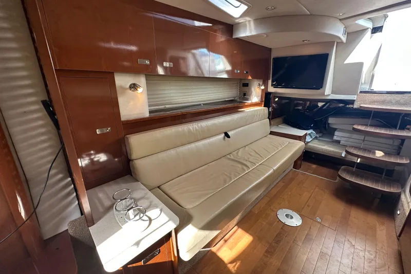 Slide: The Image of Luxurious interior of 2011 Sea Ray Sundancer 370 yacht with leather seating and wooden flooring. - 26