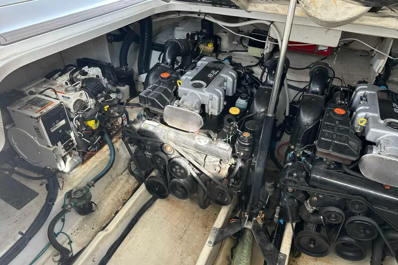 Slide: The Image of Engine compartment of a 2011 Sea Ray Sundancer 370, showcasing dual engines and mechanical components. - 27