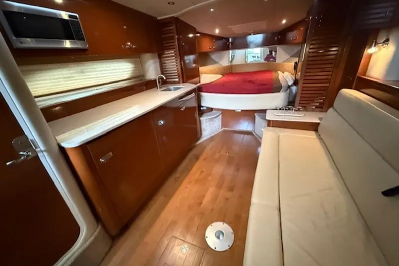 Slide: The Image of Interior of 2011 Sea Ray Sundancer 370 yacht with kitchen, seating, and bed. - 7