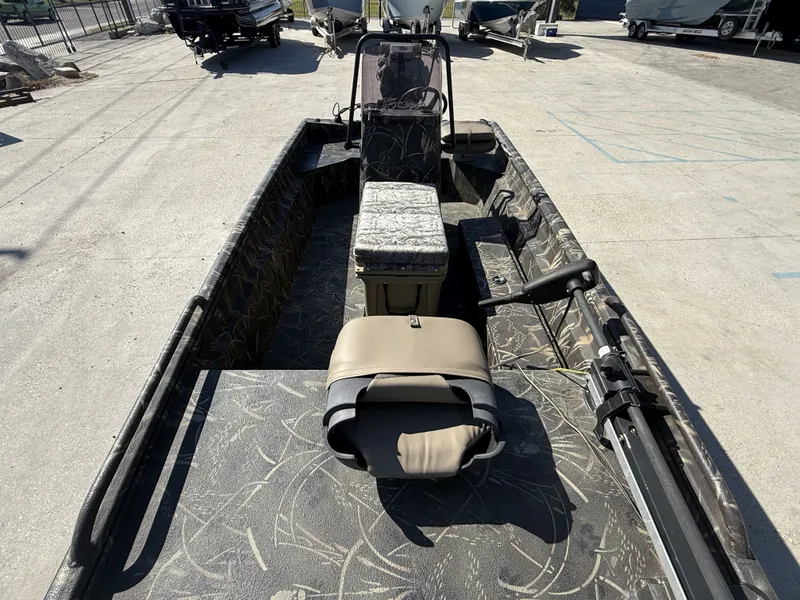 Slide: The Image of 2018 Excel F86 boat with camouflage design parked outdoors. - 11