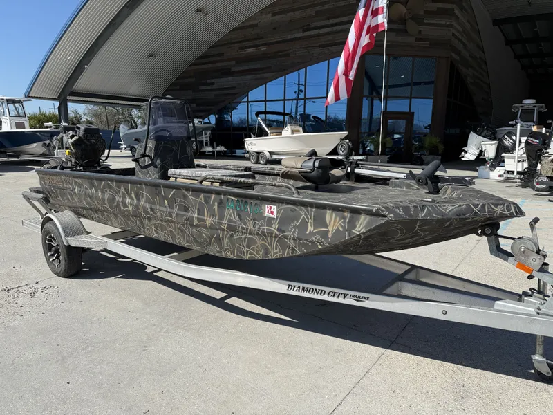 Slide: The Image of 2018 Excel F86 boat on trailer in front of building. - 6