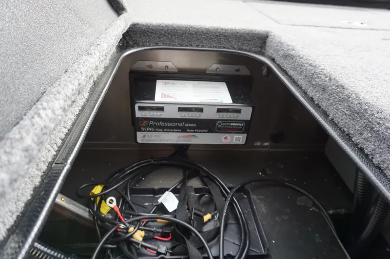 Slide: The Image of Battery compartment of 2026 Ranger RT188P with charger and cables. - 6