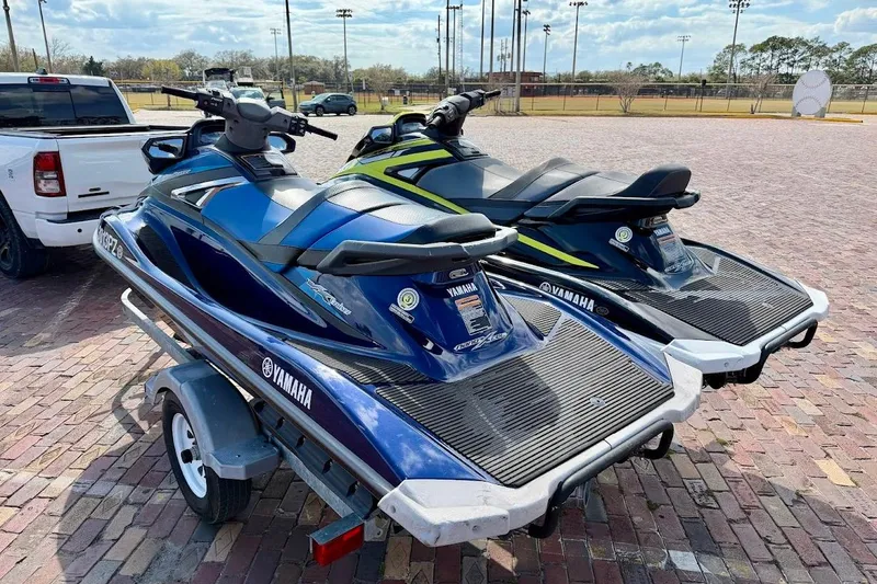 Slide: The Image of Two 2019 Yamaha WaveRunner VX Deluxe jet skis on a trailer in a parking lot. - 3
