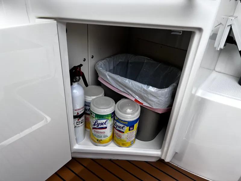 Slide: The Image of Storage compartment in Chaparral 337 SSX boat with cleaning supplies and trash bin. - 17