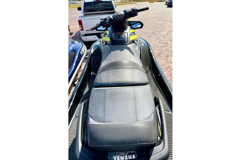 Slide: The Image of 2015 Yamaha WaveRunner VX Cruiser jet ski with black seating, parked on pavement. - 10