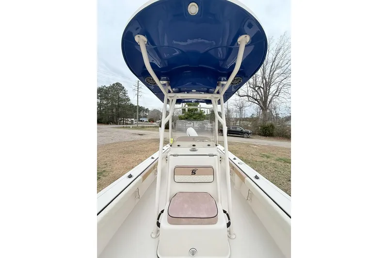 Slide: The Image of 2024 Carolina Skiff 24 Ultra Elite boat with blue T-top and spacious deck. - 10