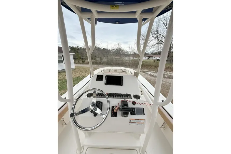 Slide: The Image of 2024 Carolina Skiff 24 Ultra Elite boat console with steering wheel and navigation equipment. - 12