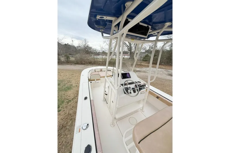 Slide: The Image of 2024 Carolina Skiff 24 Ultra Elite boat interior with steering console and seating. - 16