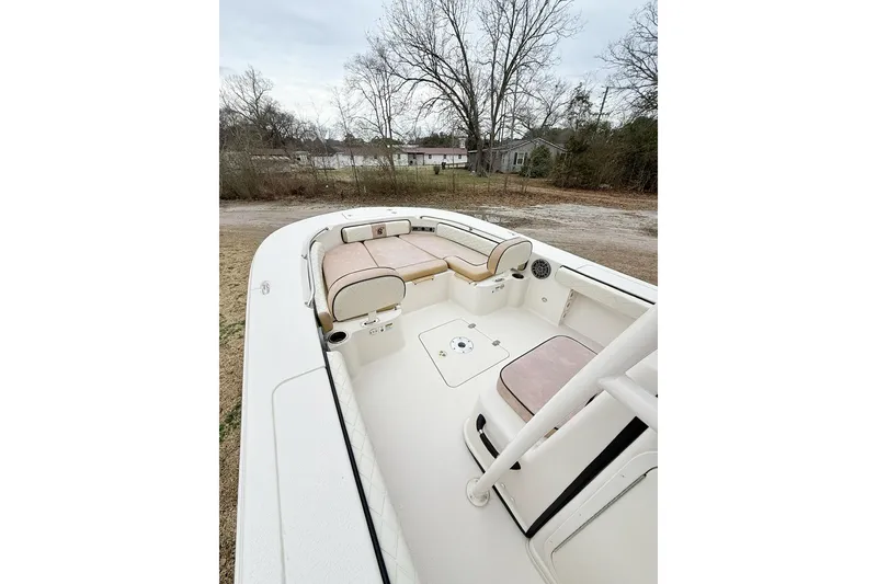 Slide: The Image of 2024 Carolina Skiff 24 Ultra Elite boat interior with seating and storage. - 9