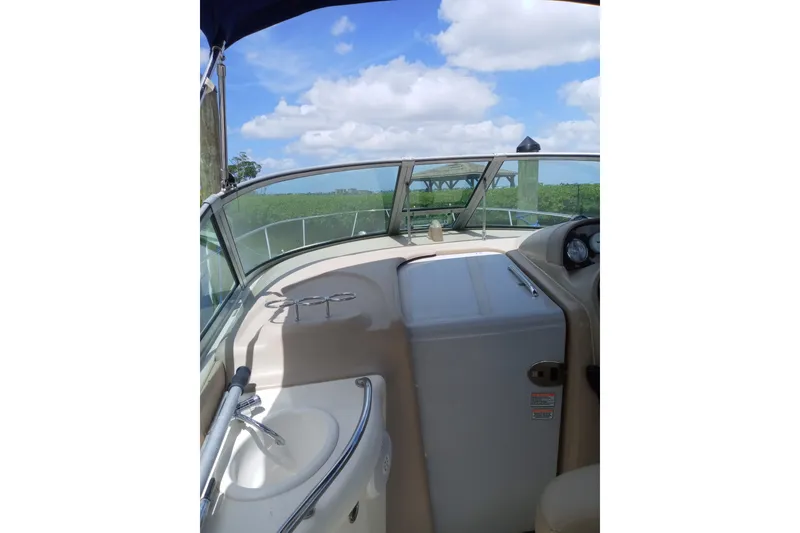 Slide: The Image of 2005 Sea Ray 300 Sundancer boat interior with sink and clear sky view. - 13
