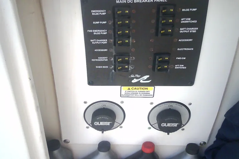 Slide: The Image of Main DC breaker panel on 2005 Sea Ray 300 Sundancer boat, featuring various switches and controls. - 17