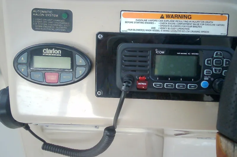 Slide: The Image of Control panel of a 2005 Sea Ray 300 Sundancer with radio and warning label. - 19