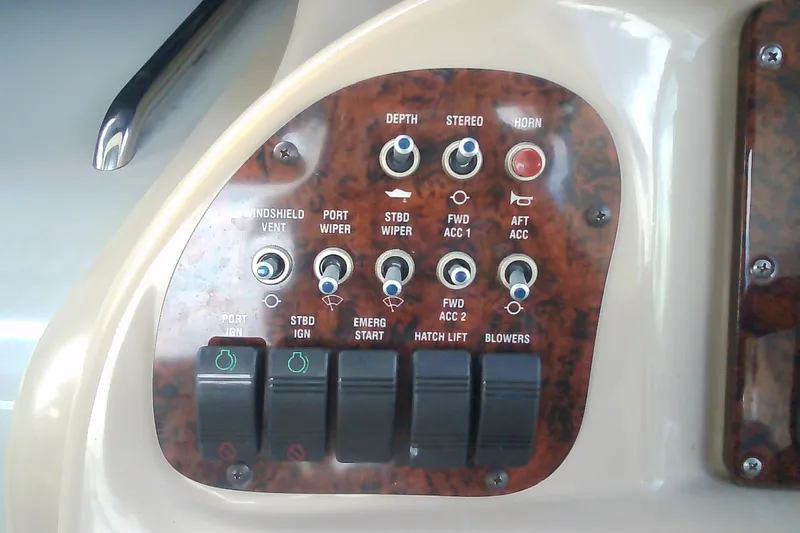Slide: The Image of Control panel of a 2005 Sea Ray 300 Sundancer boat with various switches and buttons. - 20