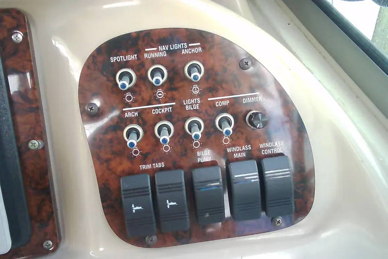 Slide: The Image of Control panel of a 2005 Sea Ray 300 Sundancer boat with various switches and dials. - 21