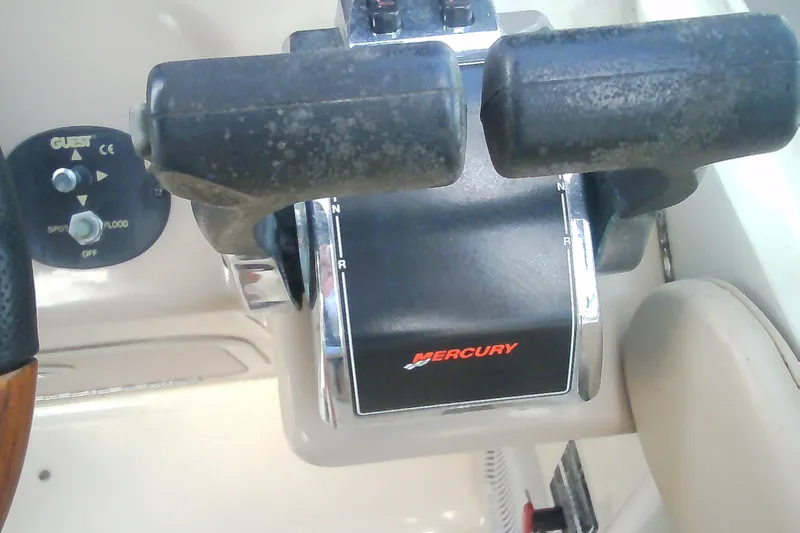 Slide: The Image of Throttle controls of a 2005 Sea Ray 300 Sundancer boat with Mercury branding. - 23