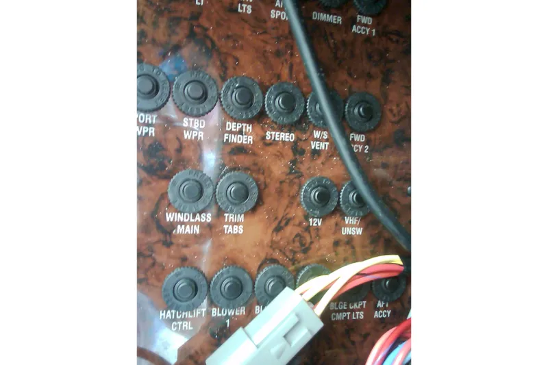 Slide: The Image of Control panel of a 2005 Sea Ray 300 Sundancer boat with labeled switches and wiring. - 25
