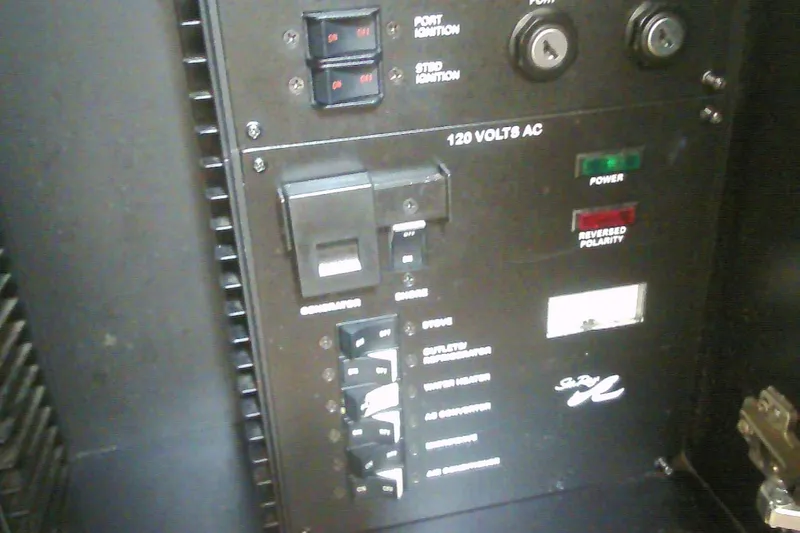 Slide: The Image of Electrical panel of 2005 Sea Ray 300 Sundancer boat, showing switches and indicators. - 34