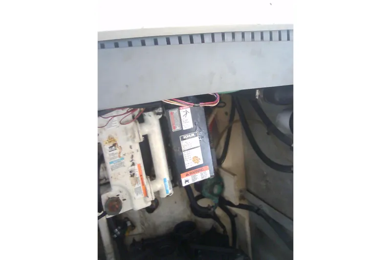 Slide: The Image of Engine compartment of 2005 Sea Ray 300 Sundancer with visible wiring and components. - 36