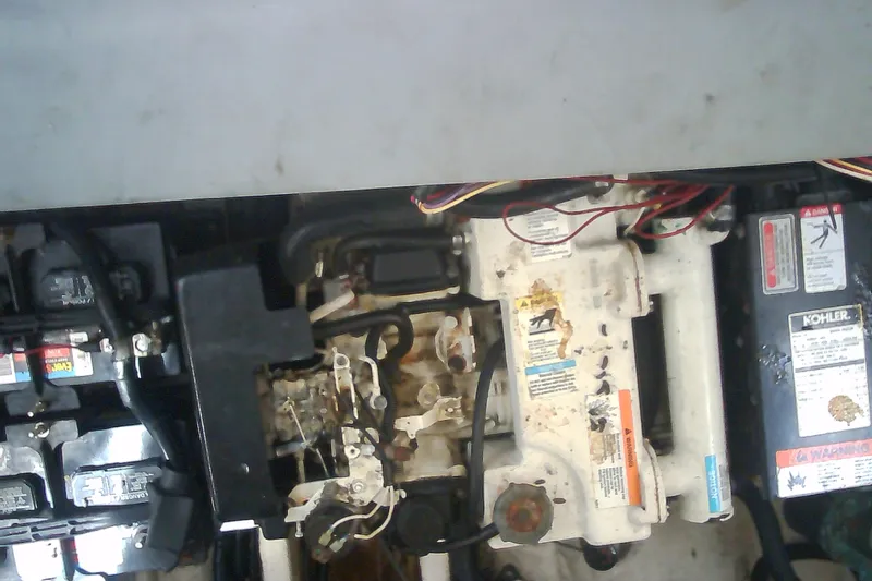 Slide: The Image of Engine compartment of a 2005 Sea Ray 300 Sundancer with visible components and wiring. - 37