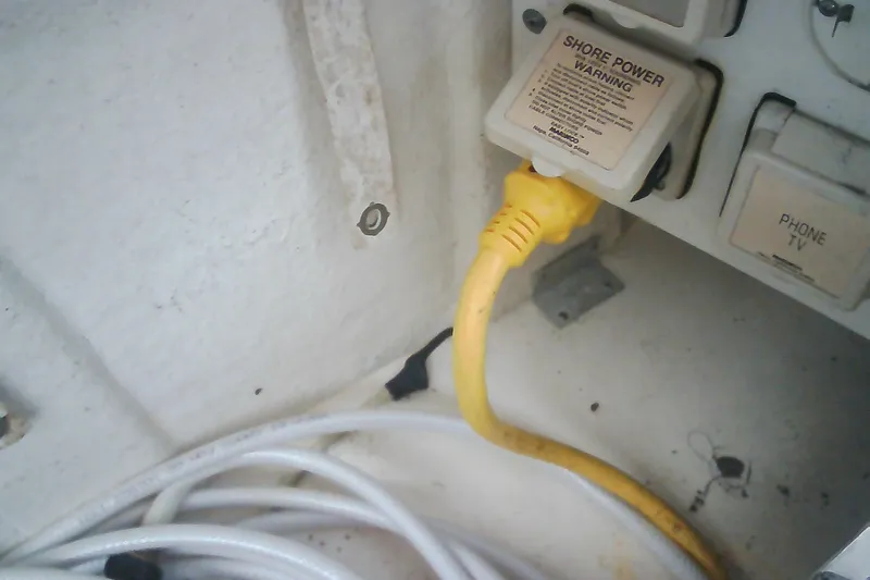 Slide: The Image of Yellow shore power cable connected on 2005 Sea Ray 300 Sundancer boat. - 48