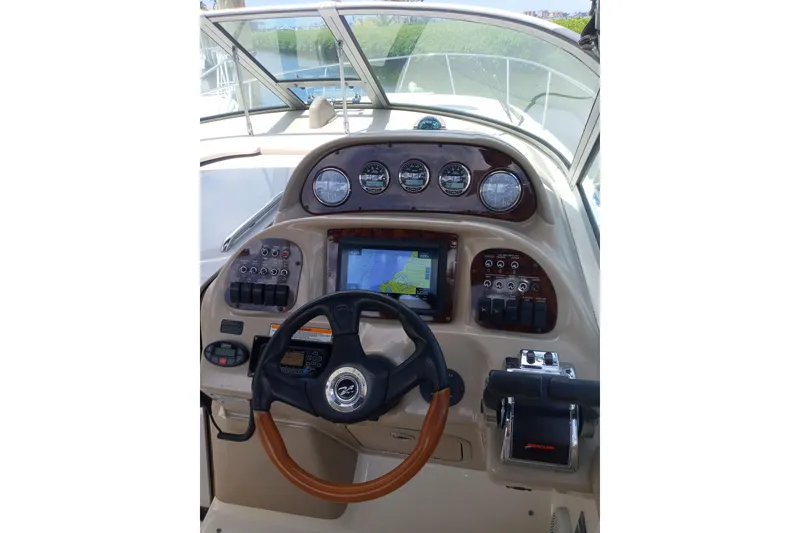 Slide: The Image of Helm of 2005 Sea Ray 300 Sundancer with navigation controls and gauges. - 5