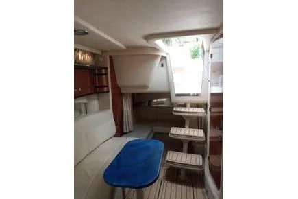 Slide: The Image of 2005 Sea Ray 300 Sundancer interior with seating, table, and steps. - 8