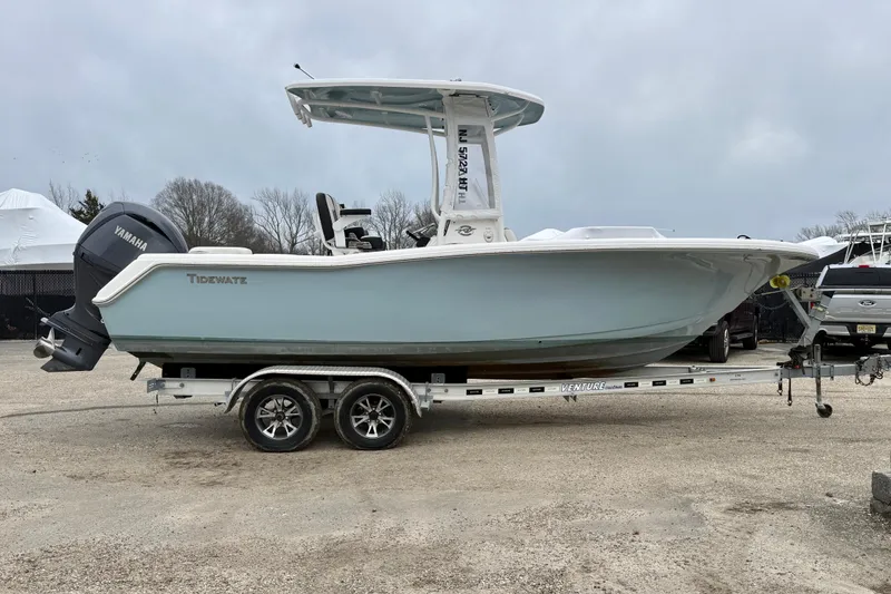 The Image of 2023 Tidewater 220 LXF boat on trailer with Yamaha engine, parked outdoors. - 0