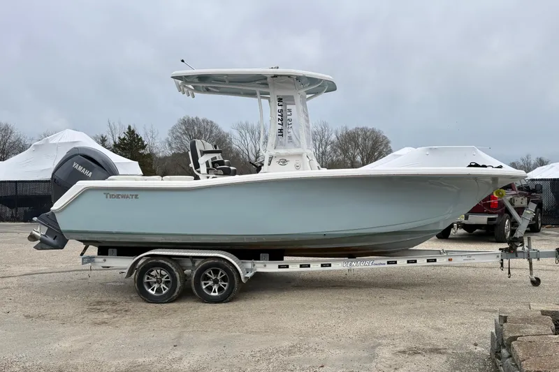 Slide: The Image of 2023 Tidewater 220 LXF boat on trailer with Yamaha engine, parked outdoors. - 1