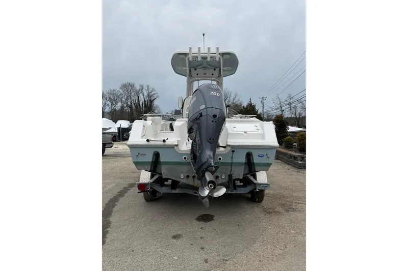 Slide: The Image of 2023 Tidewater 220 LXF boat with outboard motor, parked on a trailer. - 11