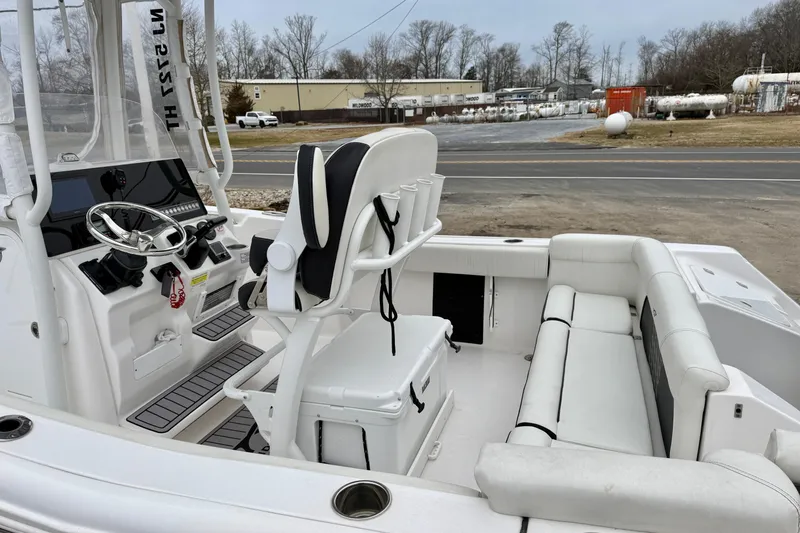 Slide: The Image of 2023 Tidewater 220 LXF boat interior with steering console and seating. - 14