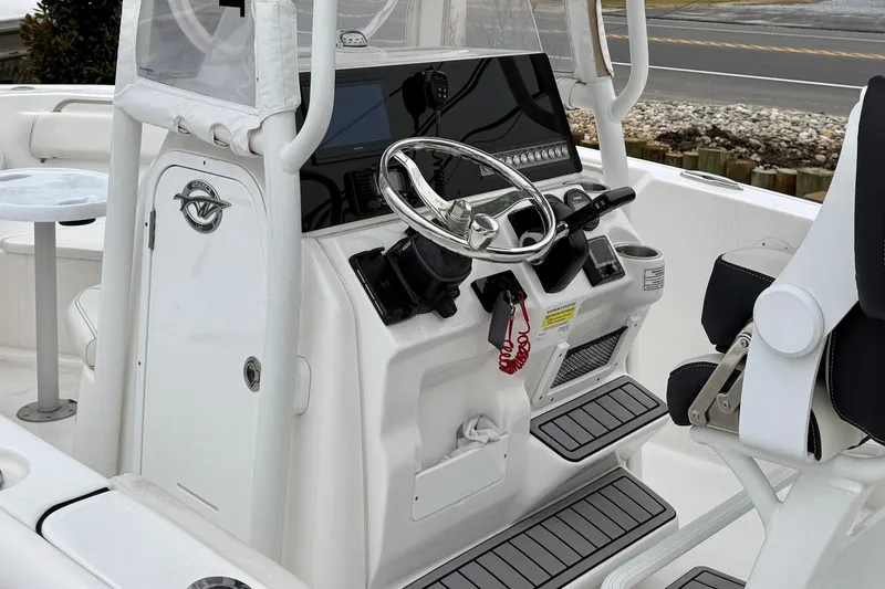 Slide: The Image of 2023 Tidewater 220 LXF boat interior with steering console and seating. - 16