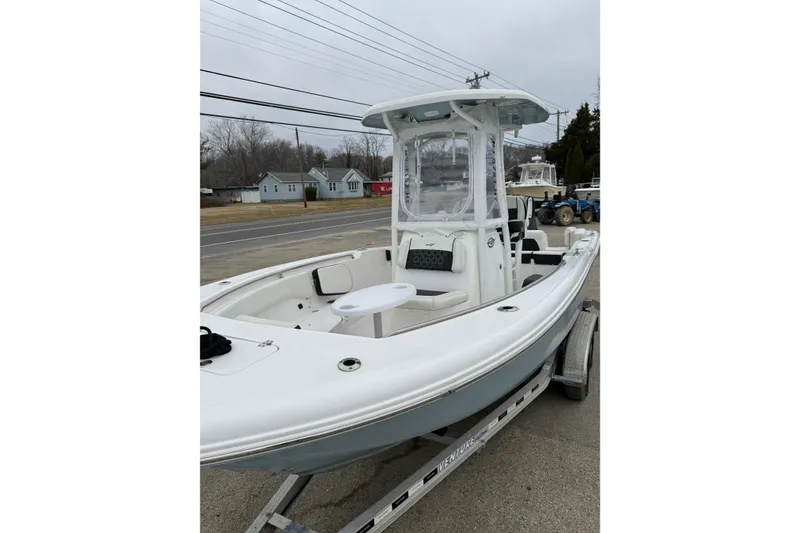 Slide: The Image of 2023 Tidewater 220 LXF boat on trailer, featuring sleek design and spacious deck. - 19