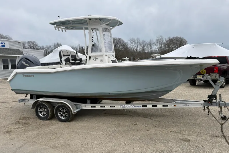 Slide: The Image of 2023 Tidewater 220 LXF boat on trailer, parked outdoors. - 2