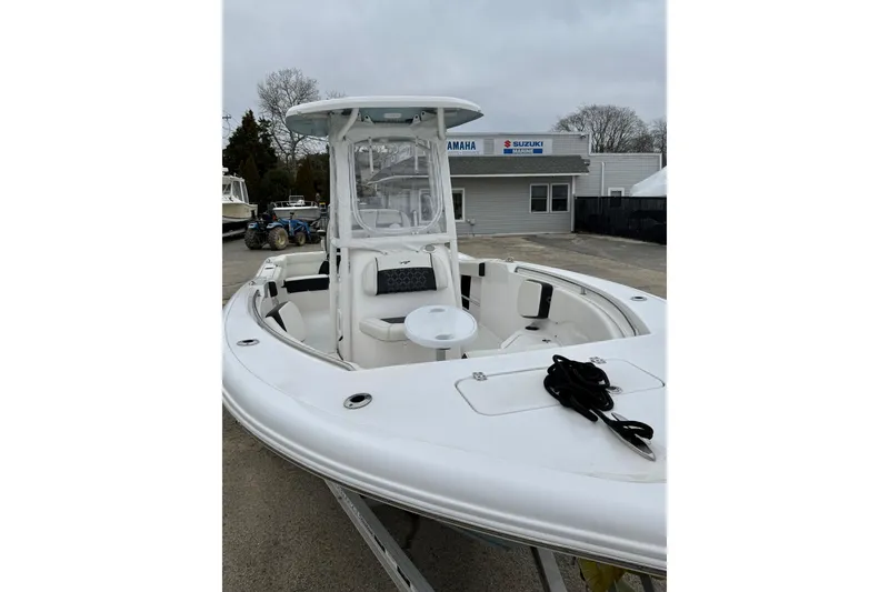Slide: The Image of 2023 Tidewater 220 LXF boat with seating and console, displayed outdoors. - 20