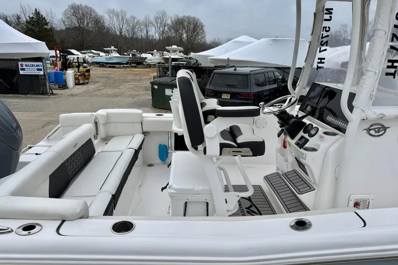 Slide: The Image of 2023 Tidewater 220 LXF boat interior with seating and control console. - 23
