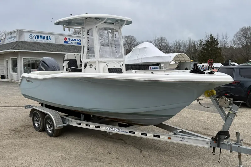 Slide: The Image of 2023 Tidewater 220 LXF boat on trailer at dealership, featuring Yamaha engine. - 4