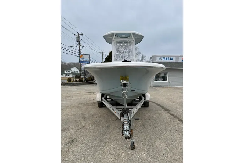 Slide: The Image of 2023 Tidewater 220 LXF boat on trailer, parked outdoors near Yamaha dealership. - 6