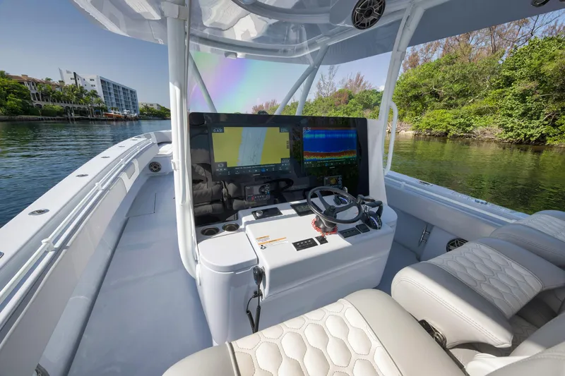 Slide: The Image of 2025 Contender 44 ST boat cockpit with advanced navigation system and luxurious seating. - 17