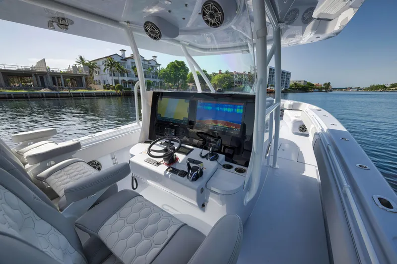 Slide: The Image of 2025 Contender 44 ST boat interior with advanced navigation system and luxurious seating. - 19