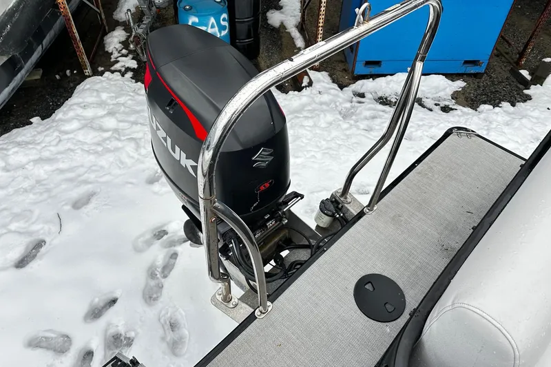 Slide: The Image of 2018 Godfrey Sweetwater 2486 C with Suzuki outboard motor in snowy setting. - 12