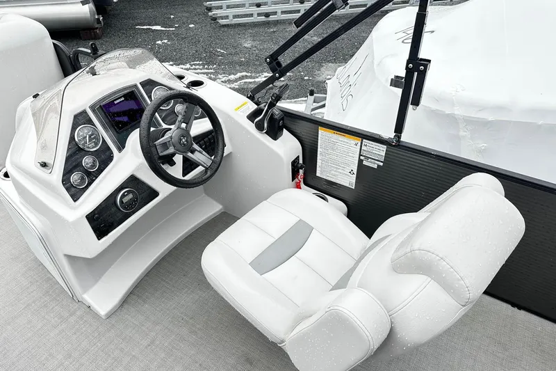 Slide: The Image of 2018 Godfrey Sweetwater 2486 C boat cockpit with steering wheel and control panel. - 4